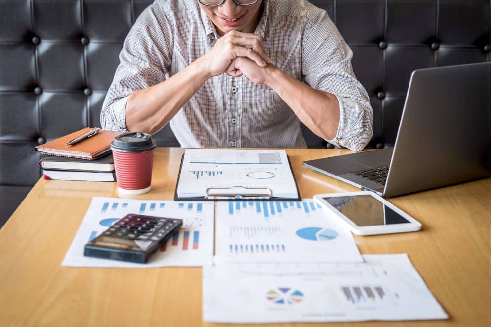 Man looking over returns from his investment property