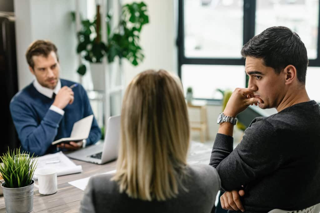 What to Look for in a Northern Colorado Realtor 5 - Black Bear people sit across the table from a realtor discussing a potential home purchase