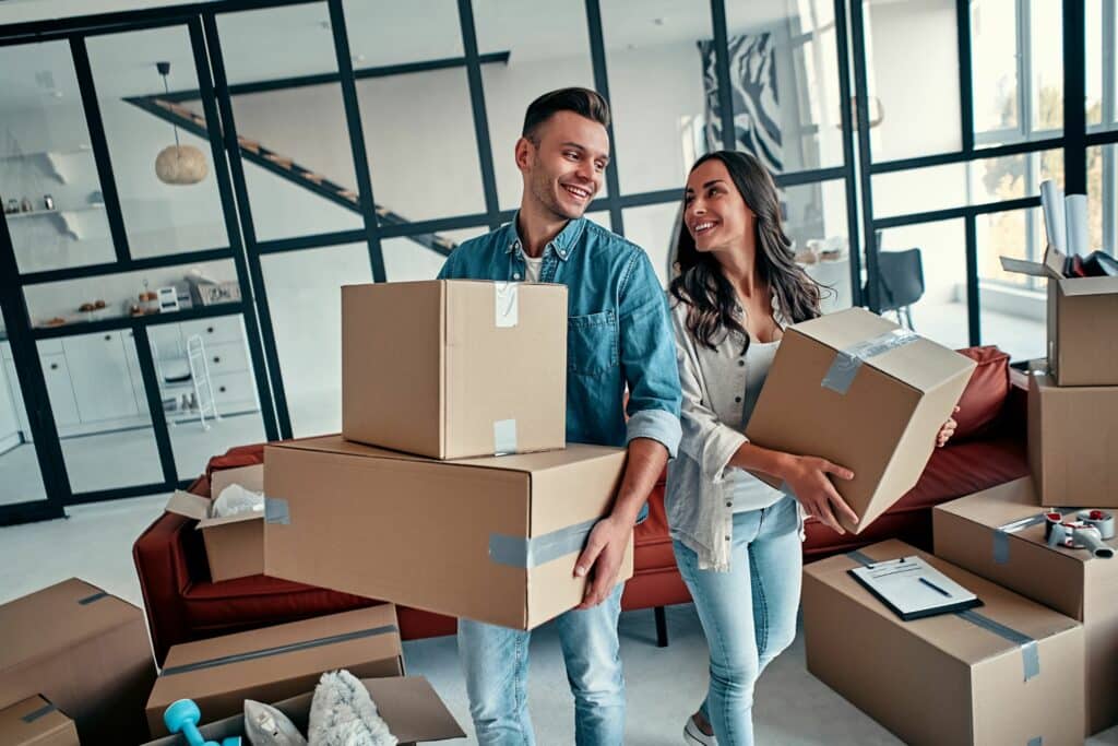 two happy tenants moving into a new property